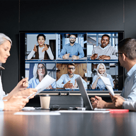 Image of corporate IT team meeting with leadership via hybrid work.